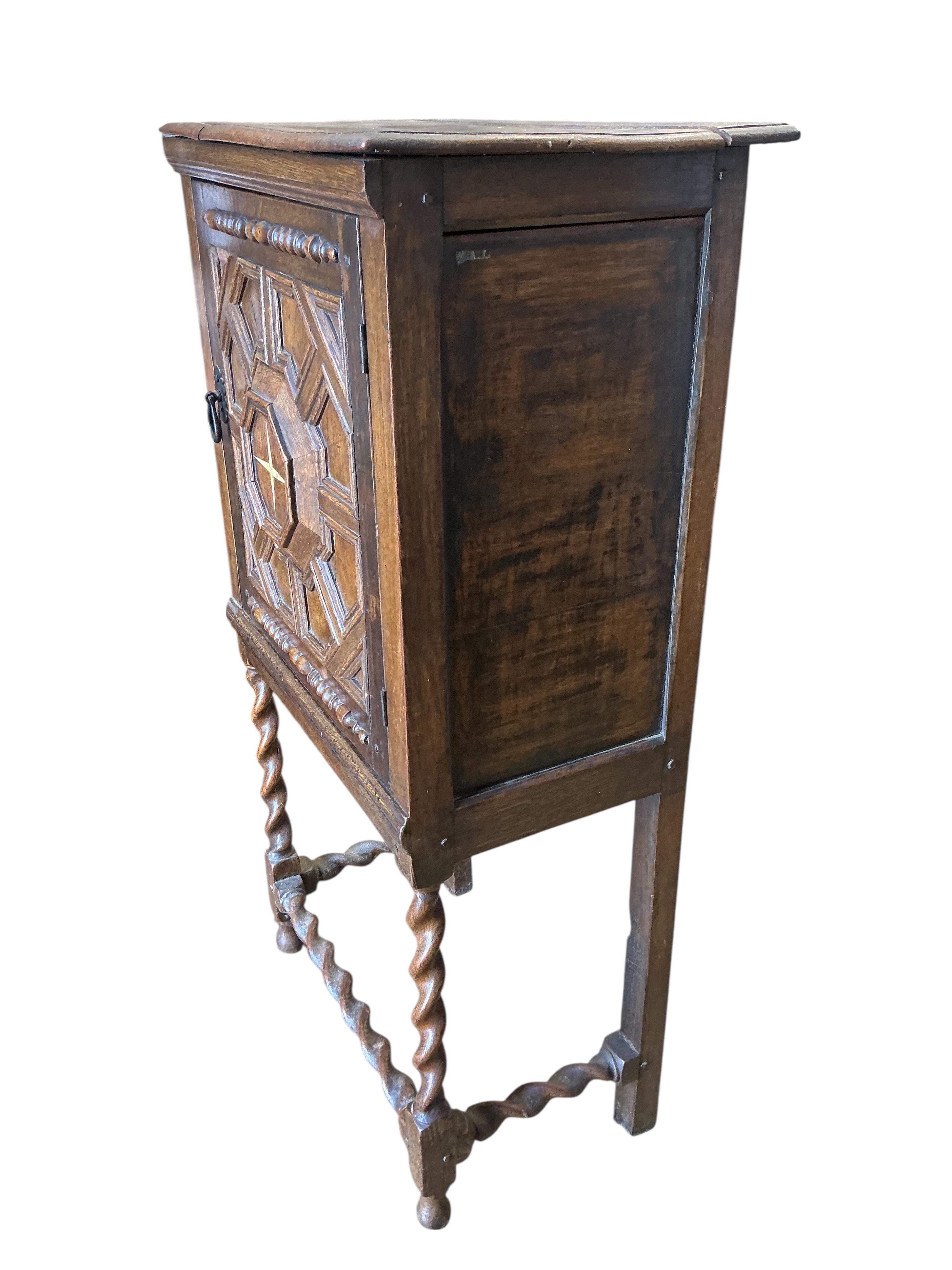 A 17th century style oak cabinet on stand, width 64cm, depth 39cm, height 120cm
